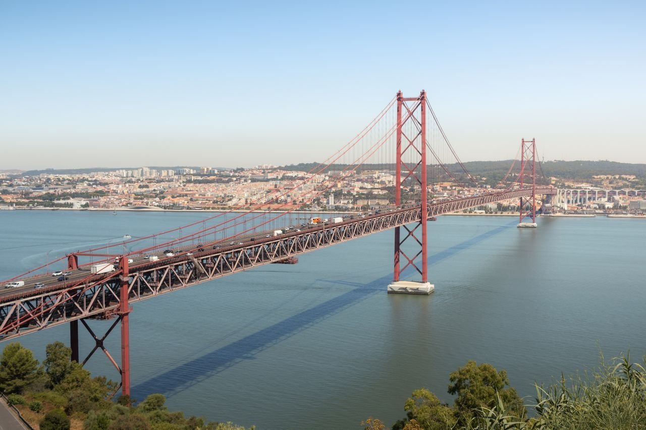 Aerial view of the iconic 25 de Abril Bridge spanning the Tagus River in Lisbon, Portugal.