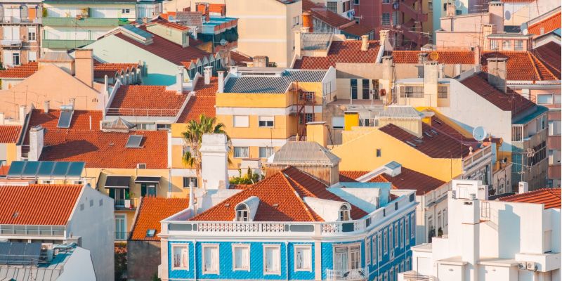 Vibrant collection of colorful rooftops in a Mediterranean urban area, highlighted by a striking blue building.