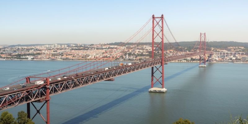 Aerial view of the iconic 25 de Abril Bridge spanning the Tagus River in Lisbon, Portugal.