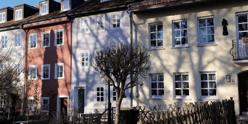 Colorful row houses in Fulda, Germany with shadows casting on a sunny day.